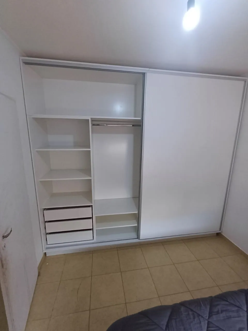Placard blanco con puerta corrediza, estantes y cajones